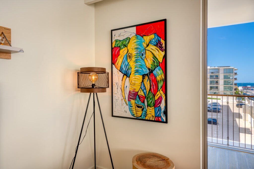 Colorful painting of an elephant on the wall in the living room of a two-bedroom apartment in Bayline Condominium, Armação de Pêra, Algarve, Portugal.